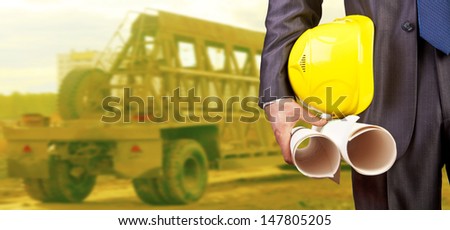 engineer yellow helmet for workers security construction worker holding paper plan in beside truck Copy space for inscription