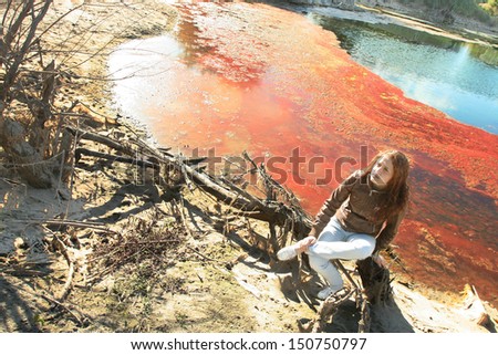 Photo of sad woman in fairy red bog . Beauty autumn   the idea of Ã?Â¢??Ã?Â¢??disaster and bad environment and pollution from emissions to fresh water Copy space for inscription