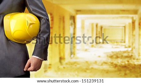 engineer yellow helmet for workers security over empty old building inside warehouse background Copy Space for inscription