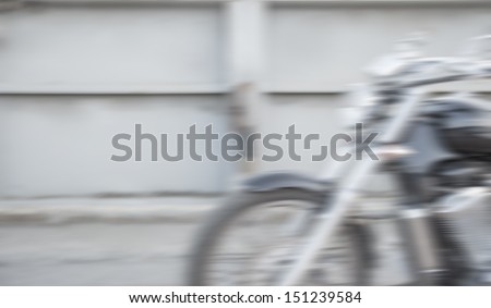 Abstract slow motion, biker riding motorbike, driver racing on the big red bike, side view, blur movement, summer road trip, speed concept