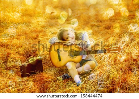 Country latin hispanic girl playing guitar at haystack Copy space for inscription With bokeh background