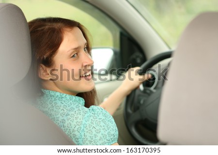 young woman in car - indoor keeps wheel turning around looking at passengers sitting side idea of taxi driver talking to policeman companion companion who asks for directions right drive Documents