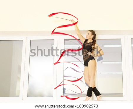 Portrait of Slim flexible cut woman rhythmic gymnastics art dancer on wall and window background Young adult Girl in transparent sexy lace black dress and Stockings