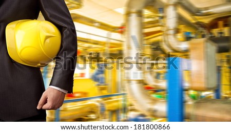Man working in oil or gas refinery, turning on and off the pipeline valve torso and hand engineer yellow helmet for workers security construction worker No face Unrecognizable person