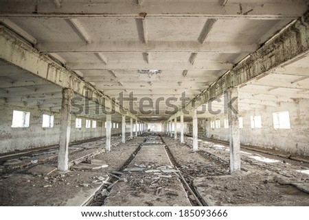 Photo of empty space concrete room interior with light in windows and dirty beam in perspective Background of industrial warehouse with old trash