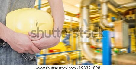 Man working in oil or gas refinery, turning on and off pipeline valve torso and hand engineer yellow holding paper plan, helmet for workers security construction worker No face Unrecognizable person