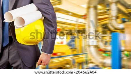 Man working in oil or gas refinery, turning on and off pipeline valve torso and hand engineer yellow holding paper plan, helmet for workers security construction worker No face Unrecognizable person