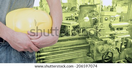 No face person Unrecognizable person Operator holding yellow helmet on metal working machine background Copy space for inscription