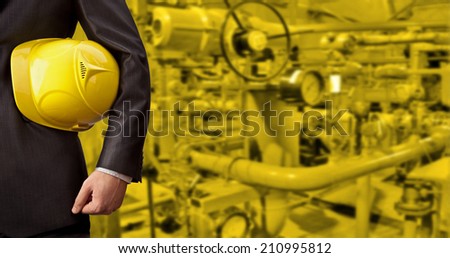 Business Man working in oil or gas refinery, turning on and off the pipeline valve torso and hand engineer yellow helmet for workers security construction worker No face Unrecognizable person