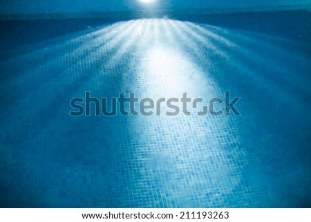 abstract view of smokey water background and ceramic- mosaic floor in swimming pool at night
