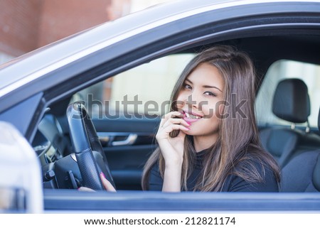 Portrait of female Young adult sexy brunette dreaming girl sitting in luxury black car Slim cute asian woman listening music inside black leather chair auto open door with leg Fingers on forehead