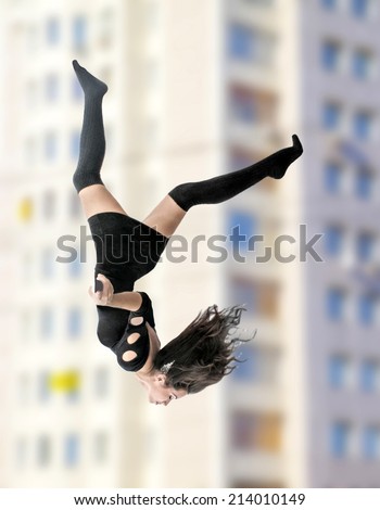A beautiful asian young adult suicide woman falling up on windows of house wall background Girl wearing short black elegant dress Empty copy space for inscription