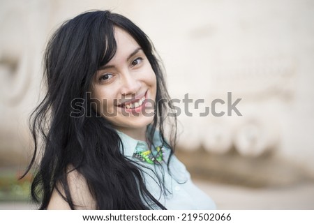 Close up Portrait of the city girl with smile on face. Summer hot day. Brunette asian woman with long hair looking at camera Empty copy space for inscription