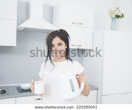 Portrait of Young adult brunette asian woman making tea or green tea on kitchen room interior background Empty copy space for inscription Girl with coffee cup