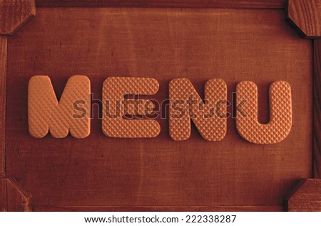 board frame on wall  in restaurant or caffee With word - Menu And letter,  On brown wooden texture Background Empty copy space for inscription