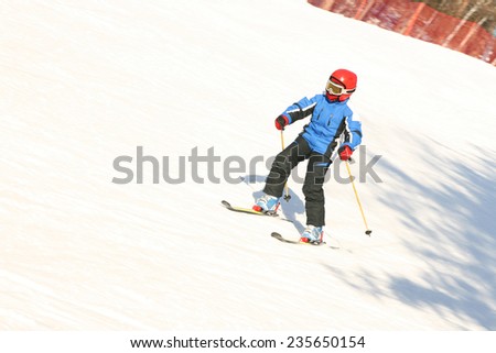 young Boy in ski mask learning skiing on snow downhill Empty copy space for inscription
