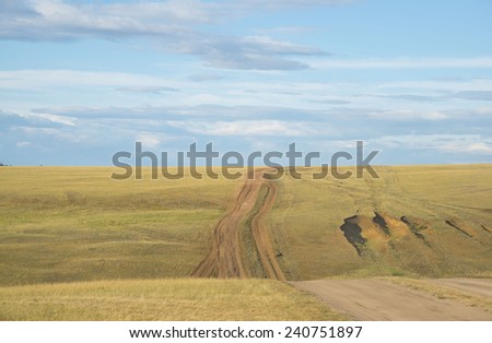 Nature tourism Background of land road on hill in green and yellow dry grass and blue sky with clouds Baikal Russia backdrop Empty copy space for inscription No people and object Road in Heaven