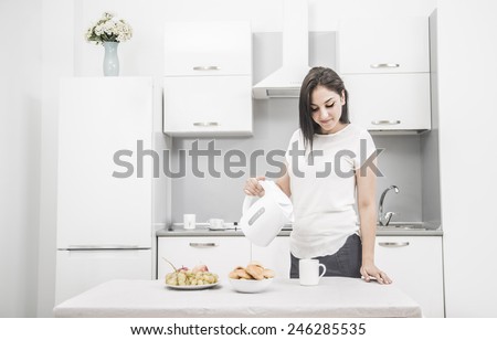 Portrait of Young adult brunette asian woman making tea or green tea on kitchen room interior background Food Vegetables and cookie in white dish plate On table Empty copy space for inscription