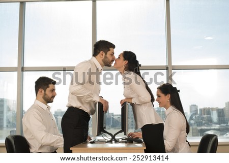 Side view of business couple Man woman kiss and type print romance message in office Pair sit on table against blue sky window background Idea concept of dating site. love letters