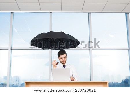 Alone handsome Businessman in his office holding black umbrella against city town blue sky glass window background Idea concept of  protect  confidentiality information Empty space for inscription