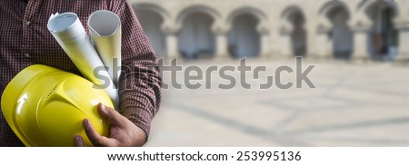 No face Unrecognizable person construction worker man holding in hands blueprint and yellow helmet on stone building arch and floor in perspective background Empty copy space for inscription