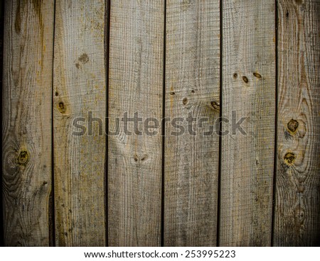 Background of natural material of Old retro vintage aged natural yellow painted wooden board shabby backdrop close up Dramatic light on surface Gray yellow brown color backdrop