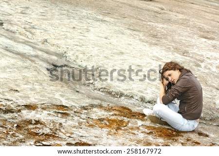 woman sitting on dry dead  land desert Sad girl cries prays for God while calling in wilderness on the earth cracked by drought idea of ecology and environmental pollution and scarcity of fresh water