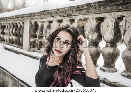 Portrait of Beautiful young adult slim asian woman stand and dream against abandoned old wall fence Brunette cute girl looking at camera in black sexy fashion dress Empty Copy space for inscription