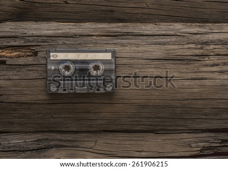 vintage hi-end transparent plastic material audio cassette on cracked old retro vintage aged wooden table texture with empty space for inscription paper sticker label  Side b