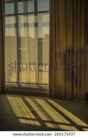 background of Contrast sun light from a window from window frame with curtains Sunset rays on stone floor texture on empty backdrop