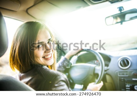 idea taxi driver talking to police companion companion who asks for directions right to drive Documents exam woman in car indoor keeps wheel turning around smiling looking at passengers in back seat