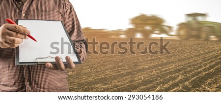 No face Unrecognizable person Businessman hold empty list of paper pen Business man wear brown shirt Copy space for inscription Experienced agronomist examining spring meadow in field Takes readings