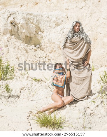Arabic Couple muslim Looking at camera Arab man and woman in white sand desert against dry desert Empty space for inscription Young rich family