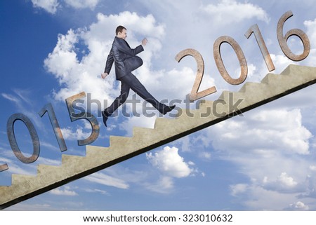 Business man stepping up on stairs to gain her success from 2015 in 2016 new year against blue sky with clouds Full length running up businessman