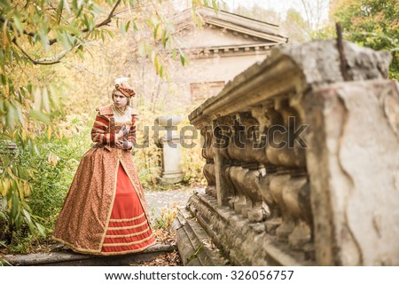 Full length woman in 16th century style red dress Young adult girl alone walk in autumn park Scary emotion on face Historical costume - Dress Spanish court elegant luxury lady