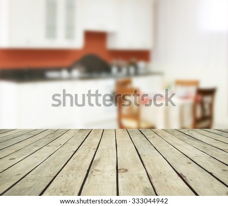 kitchen room and wooden table texture on backdrop. Selected focus empty brown wooden table and  blur background with bokeh image. Empty copy space for objects of food and inscription