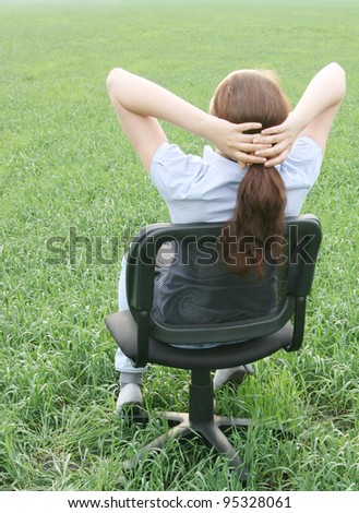 girl sitting in a chair on the nature