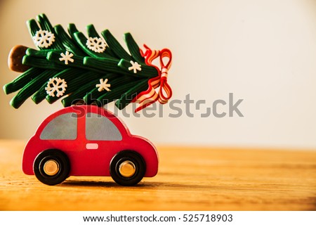 green Christmas tree on red toy car. Christmas holiday celebration concept. empty copy space for inscription. Holiday background.