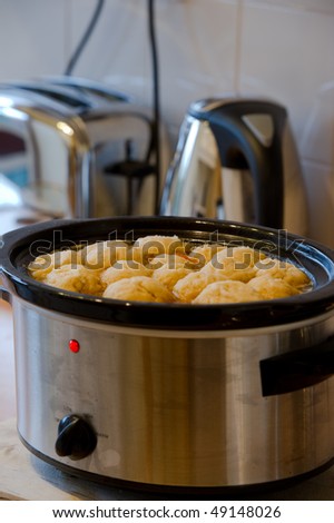 Dumplings in slow cooker with copy space.