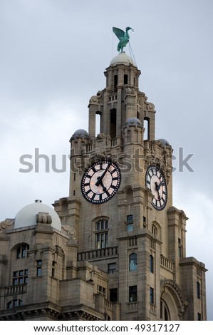 Liverpool liver building as the lights come on on the clock face with copy space.