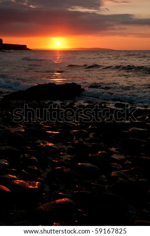 Sun setting over black point Anglesey with copy space.