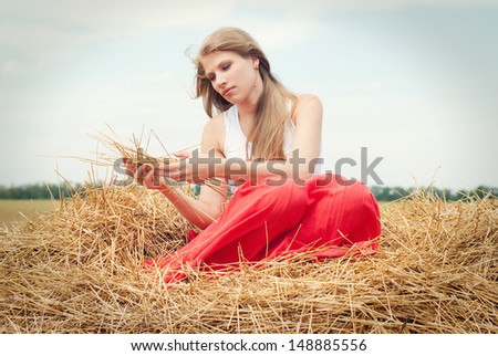 Beautiful Woman in Sun on the Haystack. Countryside, Happy People, Active People