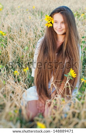 Beautiful Young Woman with very Long Hair in Countryside Outdoors. Natural Beauty, Hair Care