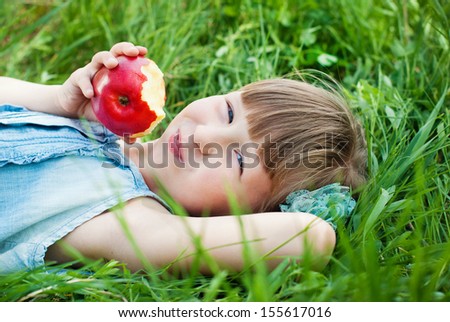 Happy Child in Summer.  Beautiful Girl with Red Apple in the Garden. Happy Children. Healthy Kids. Spring Time. Vacation in the Countryside.
