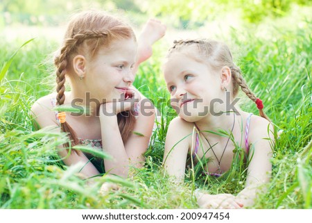 Happy girls outdoors in summer. Happy children. Happy family. Red haired girls