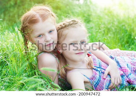 Happy girls outdoors in summer. Happy children. Happy family. Red haired girls