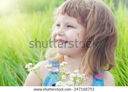 Happy Child in Summer.  Beautiful Girl with Flowers in the Garden. Happy Children. Healthy Kids. Spring Time. Vacation in the Countryside.