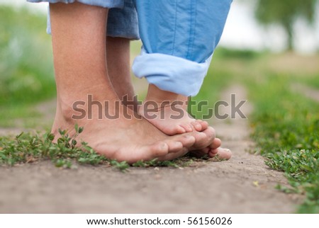 Happy Family on a Walk in Summer. Child with Father Together. Feet Barefoot on Green Grass. Healthy Lifestyle. Dad and Son. Spring Time