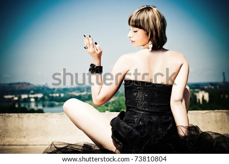 Beautiful woman with gun in her hand