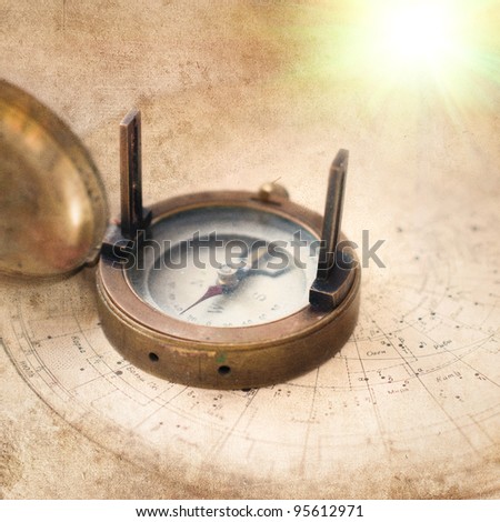 old compass on vintage celestial map